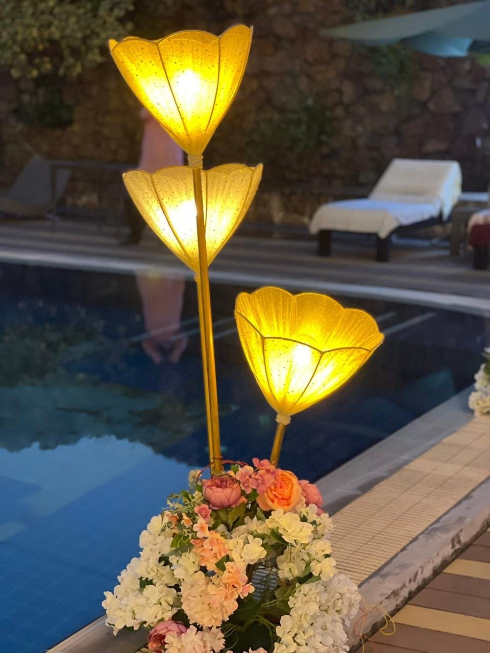 Lamplight across the pool in the evening